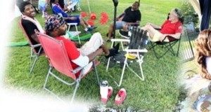 Family in lawn chairs on the grass