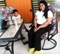 A young woman and a toddler on the patio