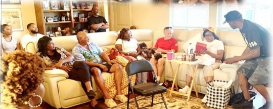 Family crowded onto a sectional sofa