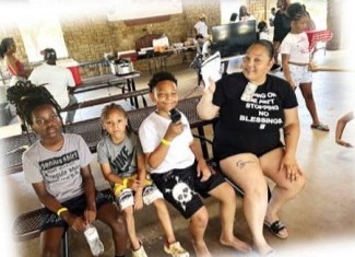 Kids and a woman on a bench