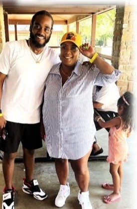 A man and a woman in a gold cap posing