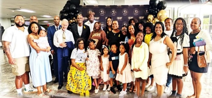 A large family group photo in the church lobby