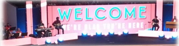 The church stage with a Welcome sign