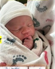 Newborn Christian swaddled in a hospital blanket