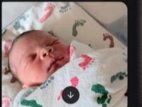 Newborn Jrue in a hospital blanket
