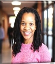 Kimberly Jones smiling, in a pink sweater