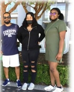 Three family members outdoors, one in a Cowboys Football shirt