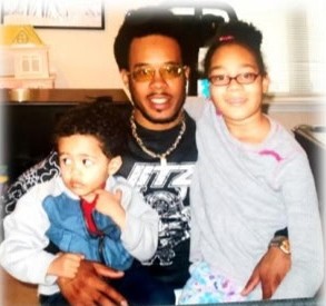 A father holding his two young children