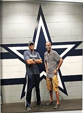 Two family members standing in front of a giant Cowboys star painted on a wall